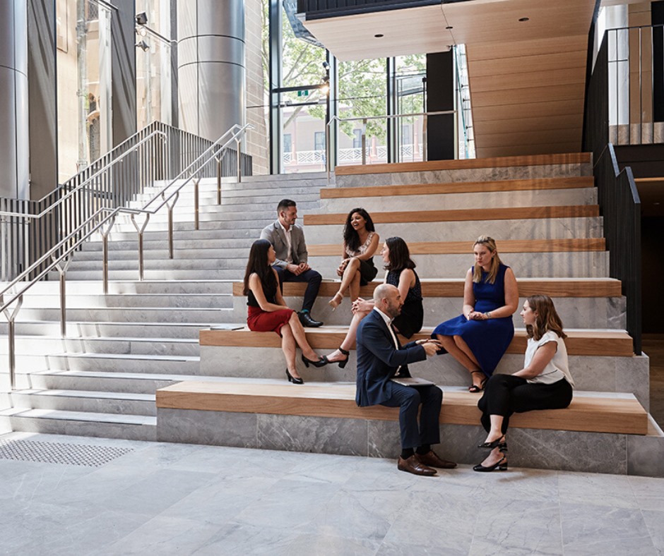 people sitting on steps inside building people sitting on steps inside building